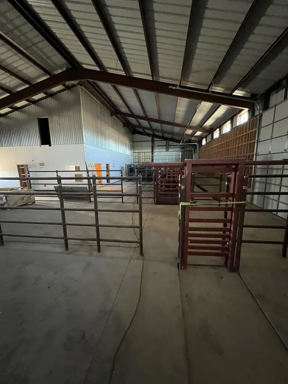 Barn interior with welded pipe livestock pen gates by Homerun Fabrication