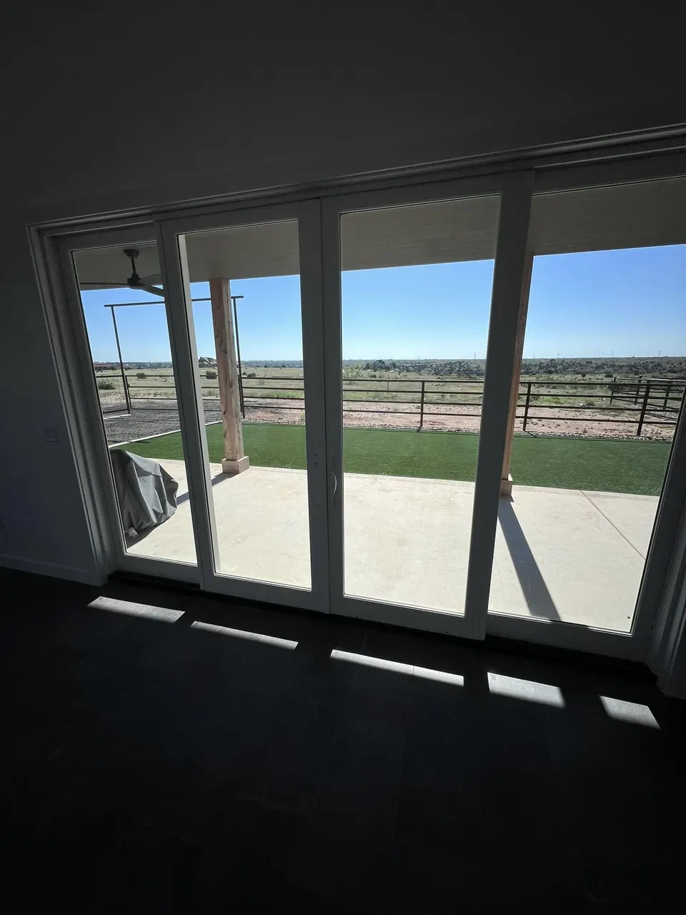 Bi-fold glass doors opening to a covered patio in a custom Homerun Fabrication living space